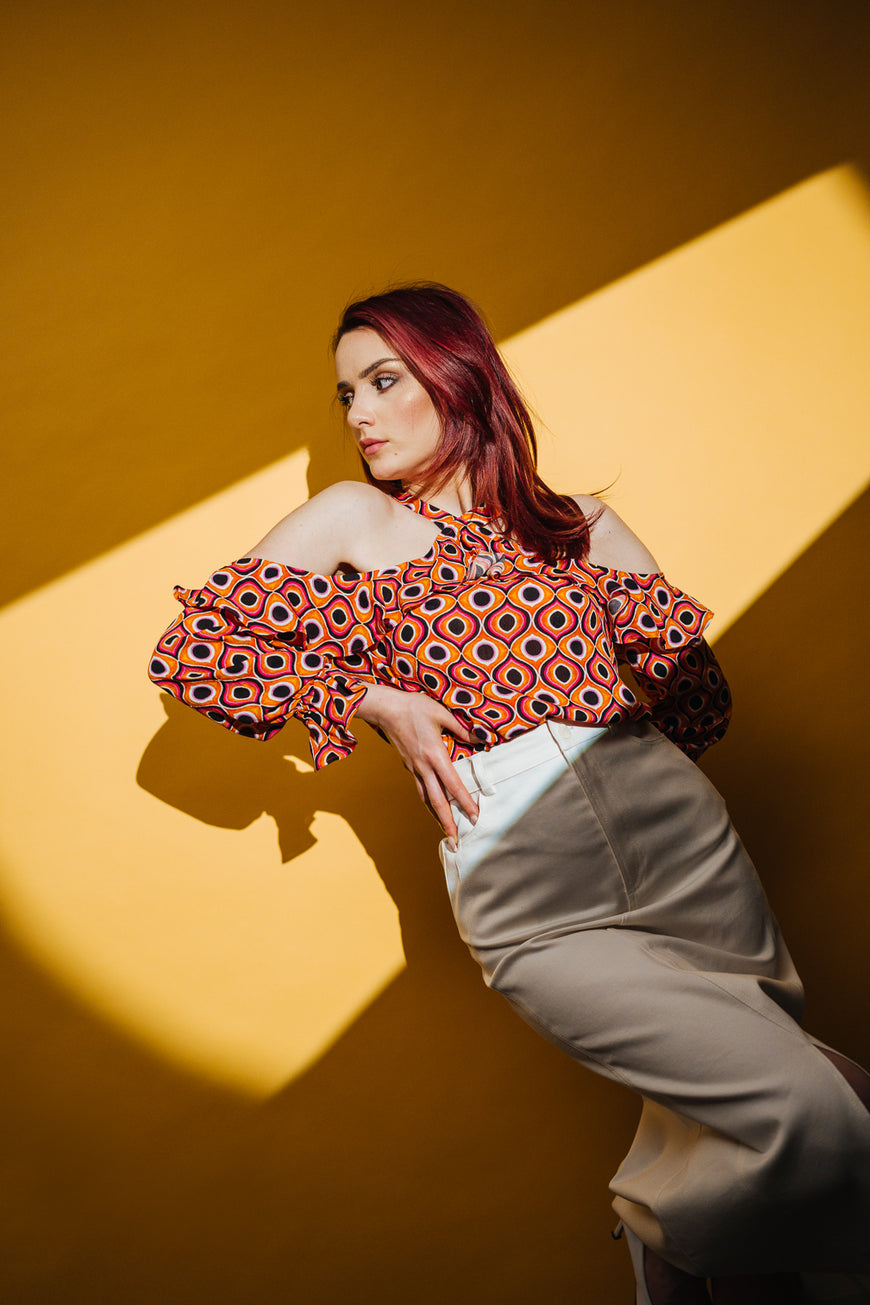 Off-shoulder orange blouse with ruffles